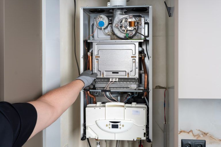 Open Domestic Gas Boiler During Maintenance Or Repair Service